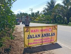 Kapolsek Nisam Pasang Spanduk Himbauan Jalan Amblas di Jalur Alternatif