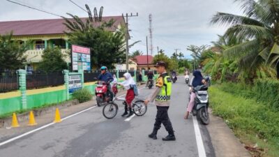 Personel Polsek Syamtalira Bayu Amankan Arus Lalu Lintas, Bantu Pelajar Menyebrang di Pagi Hari